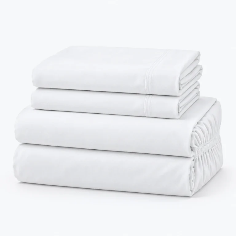 Four folded white bed sheets stacked on a white background, with elastic edges visible on the bottom sheet.