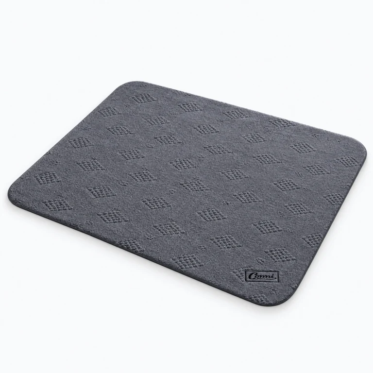 A dark gray square fabric mat with a textured pattern and rounded corners, shown on a white background.