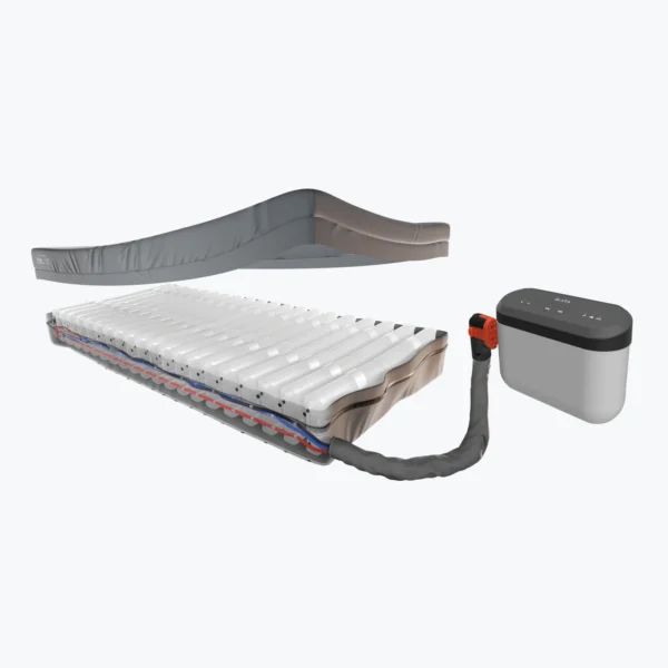 An exploded-view illustration of a layered mattress connected by a flexible hose to a compact control unit, shown on a white background.
