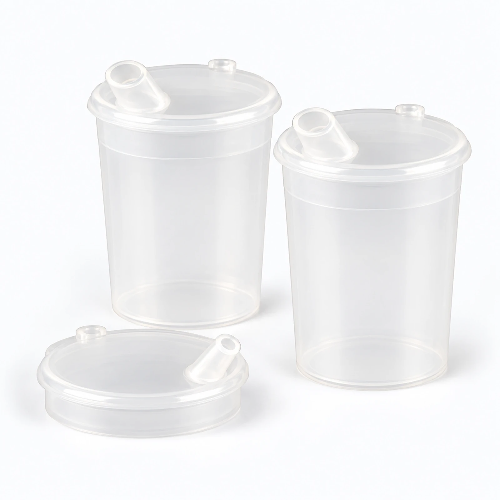 Three clear plastic drink cups with lids and sip spouts, shown on a white background.