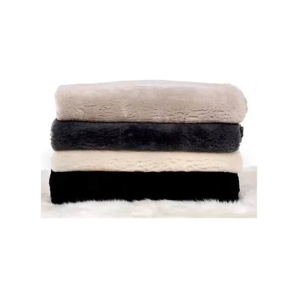 A stack of four folded plush blankets in beige, dark gray, cream, and black on a white surface.