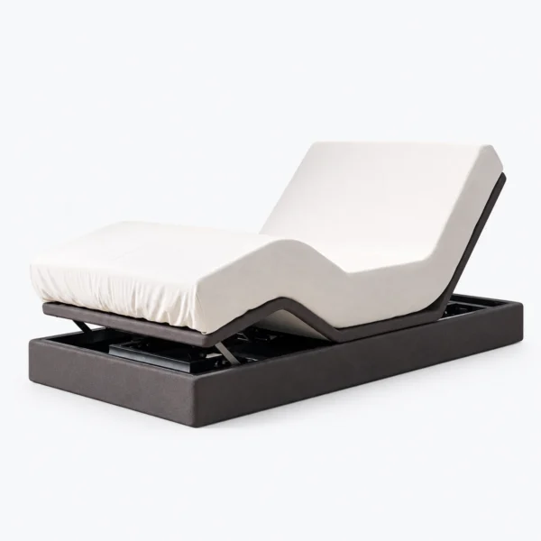 A white adjustable mattress on a dark motorized base, shown against a plain white background.
